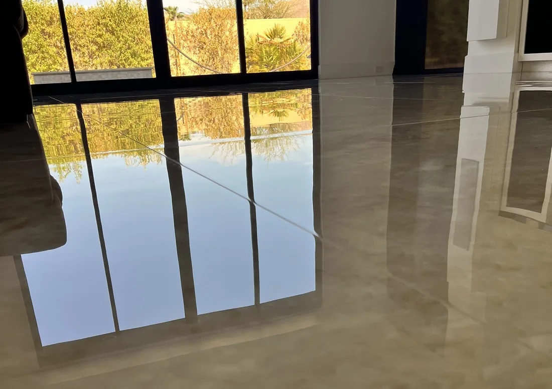 Mirror-finish close-up of polished Taj Mahal-look porcelain tile with tight grout lines reflecting the windows, by My-Key Tile & Flooring